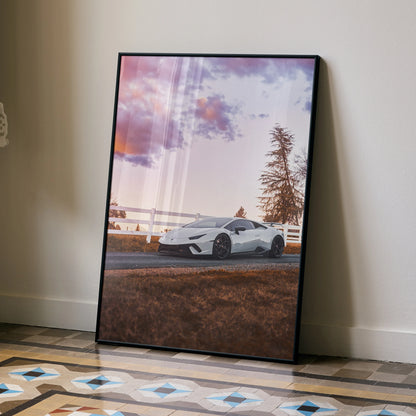 Lamborghini Huracan poster wall art with white sports car at sunset and scenic background.