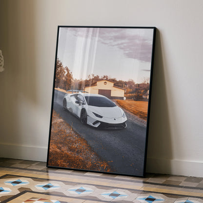 Lamborghini Huracan poster with white sports car driving down rural road at sunset wall art.