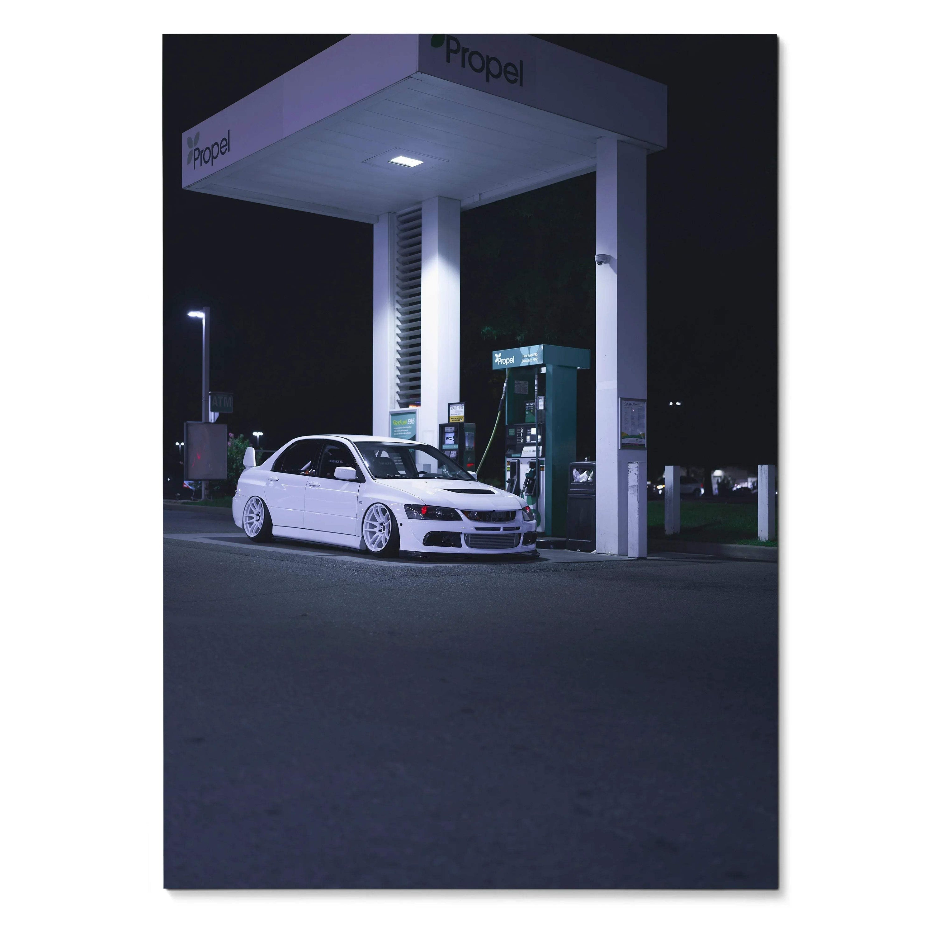 White Mitsubishi Evo 8 parked at nighttime gas station under bright lights poster wall art.