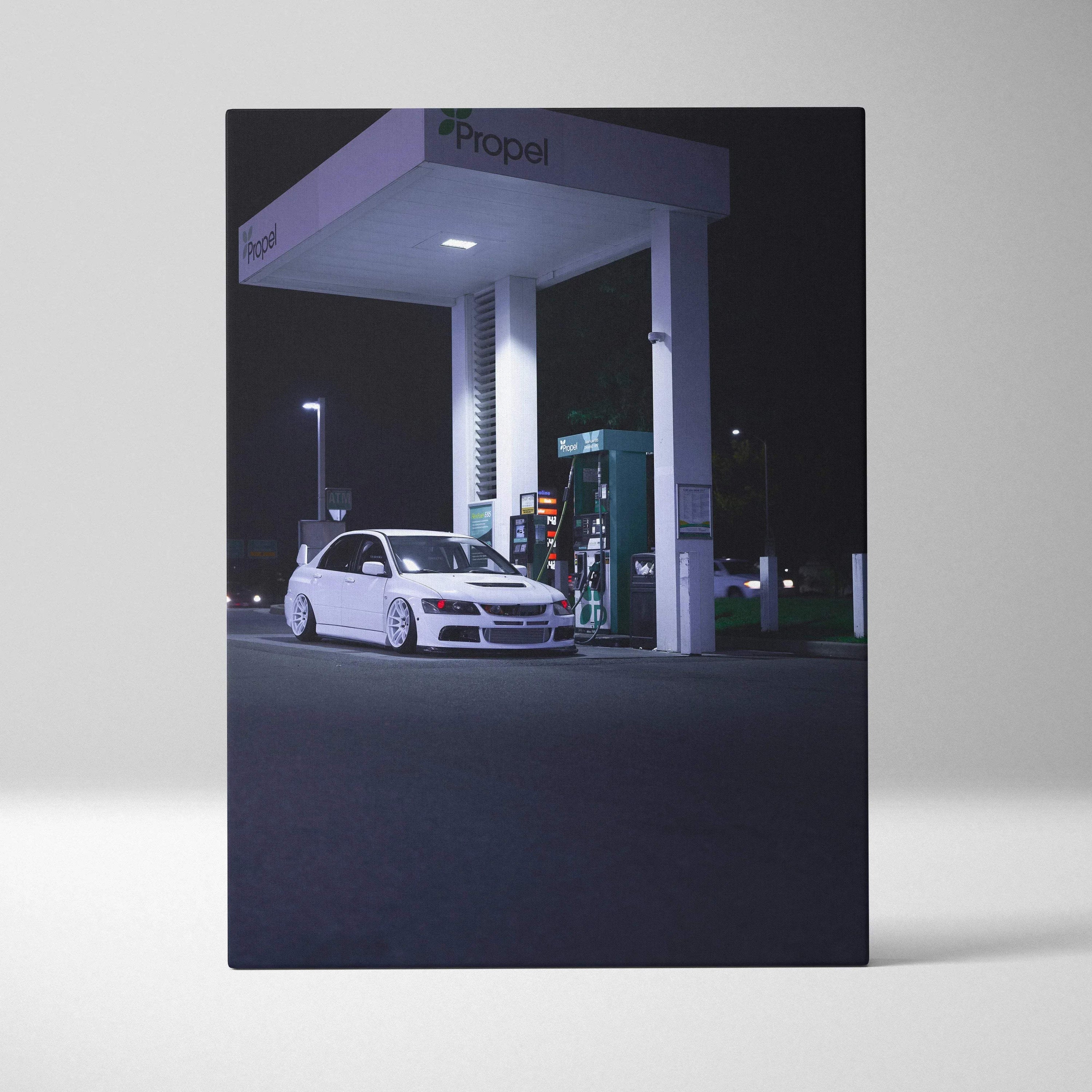Vertical canvas art of a white Mitsubishi Evo 8 parked at a dimly lit gas station at night, automotive wall art.