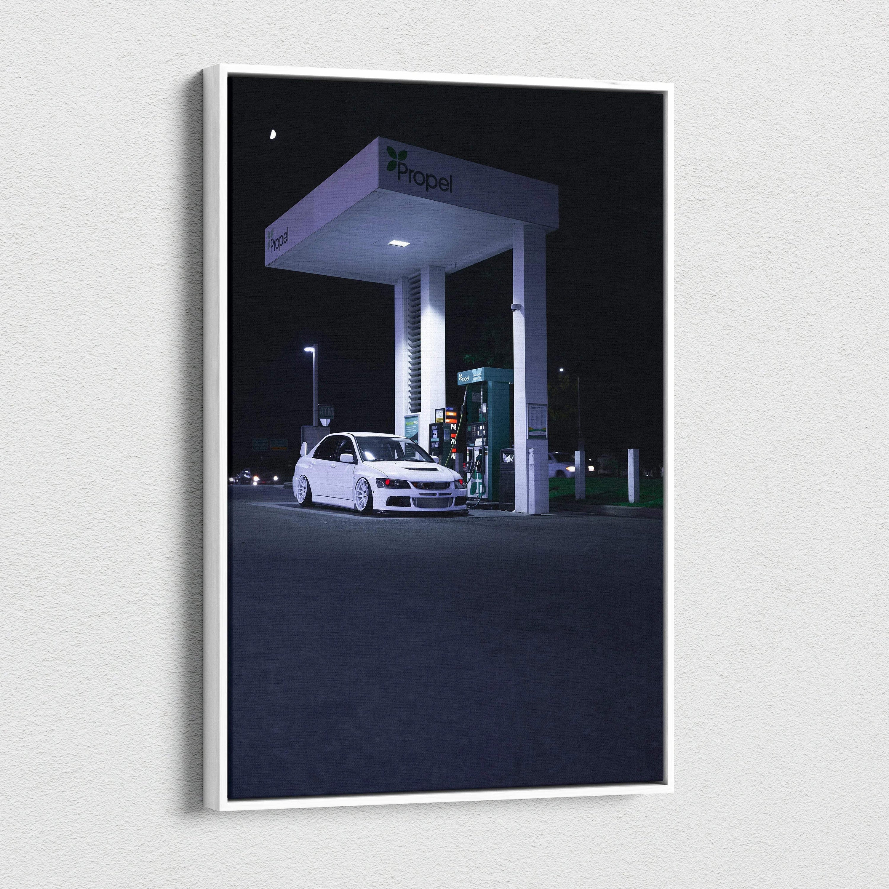 Vertical canvas art of a white Mitsubishi Evo 8 at a gas station at night, wall art with dark background.