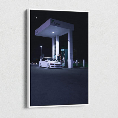 Vertical canvas art of a white Mitsubishi Evo 8 at a gas station at night, wall art with dark background.