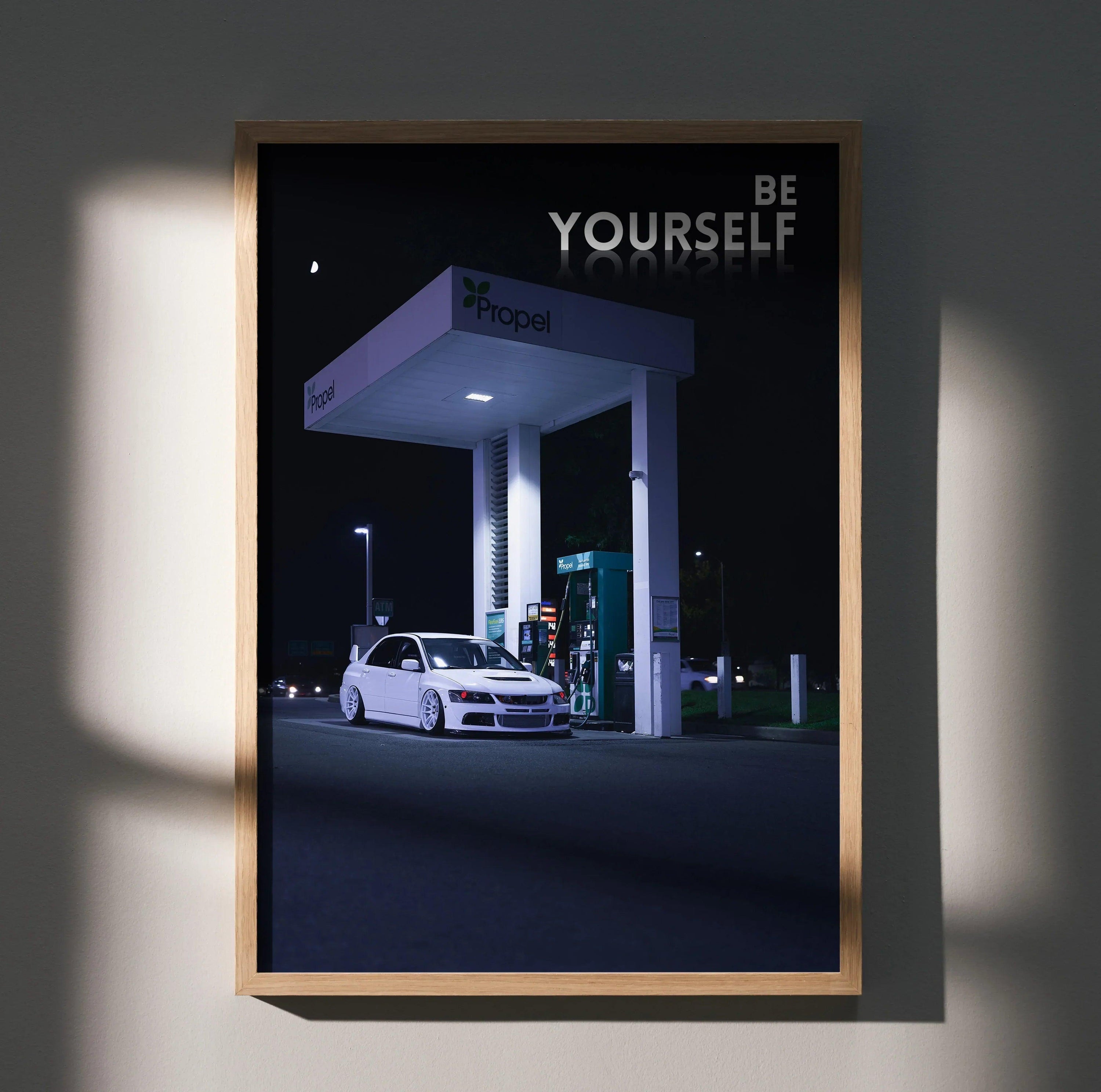 Motivational poster wall art featuring a white Mitsubishi Evo 8 at a gas station at night with "Be Yourself" text.