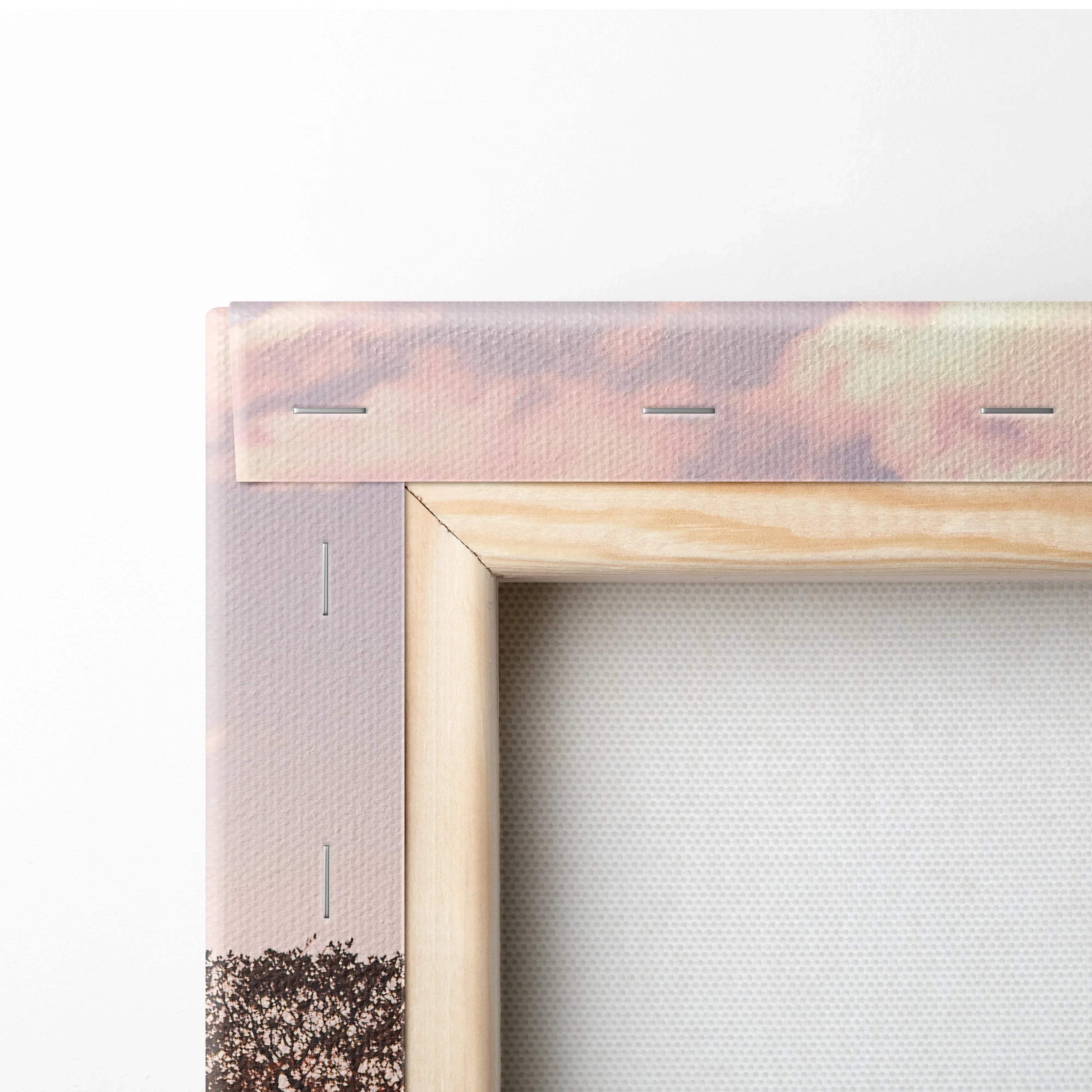 Close-up of wooden frame and stretched canvas showing Porsche GT4 wall art corner with sunset tones.