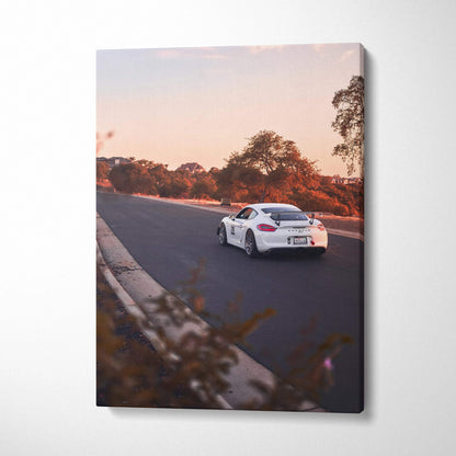 Porsche GT4 sports car driving on road at sunset canvas wall art in vertical format.