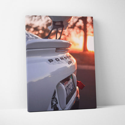 White Porsche GT4 rear detail with sunset background on vertical canvas wall art.