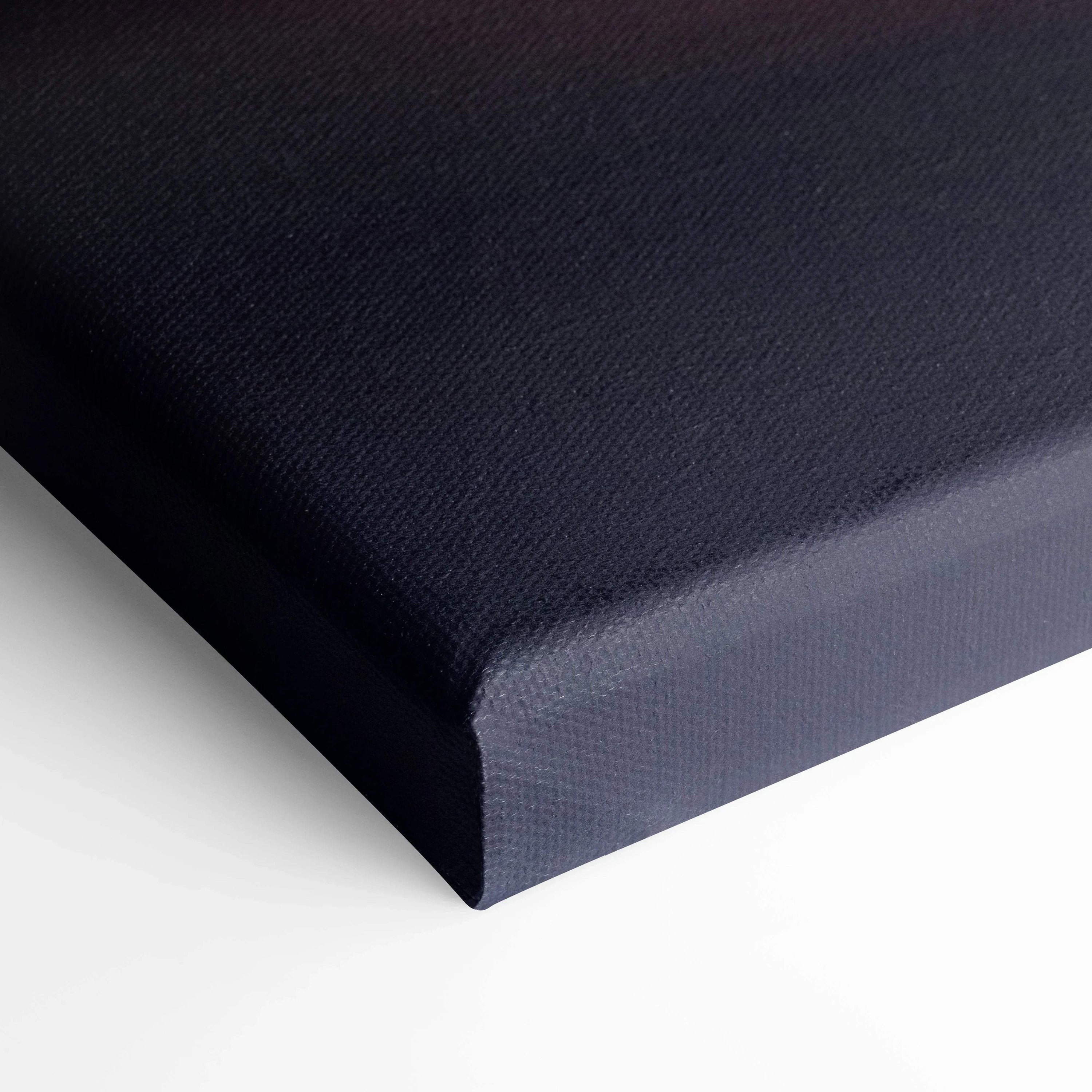 Black stretched canvas corner showing textured wall art material and wrapped edges of canvas art.