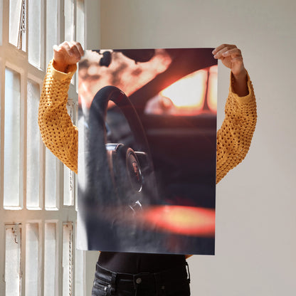 Porsche GT4 steering wheel close-up poster held as wall art with warm sunset lighting.