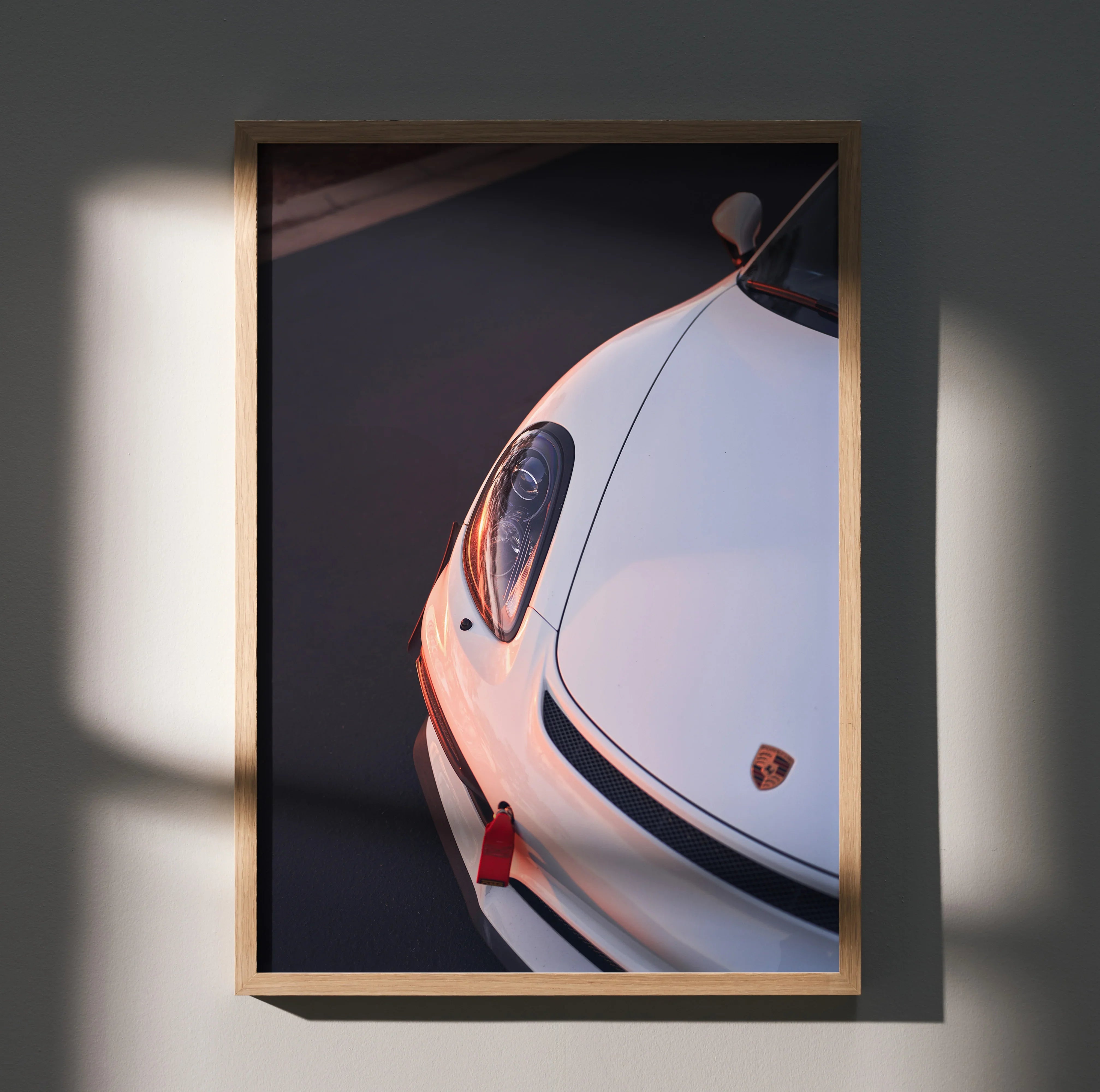 Porsche Cayman GT4 close-up poster with white car front and sleek design wall art in wooden frame.