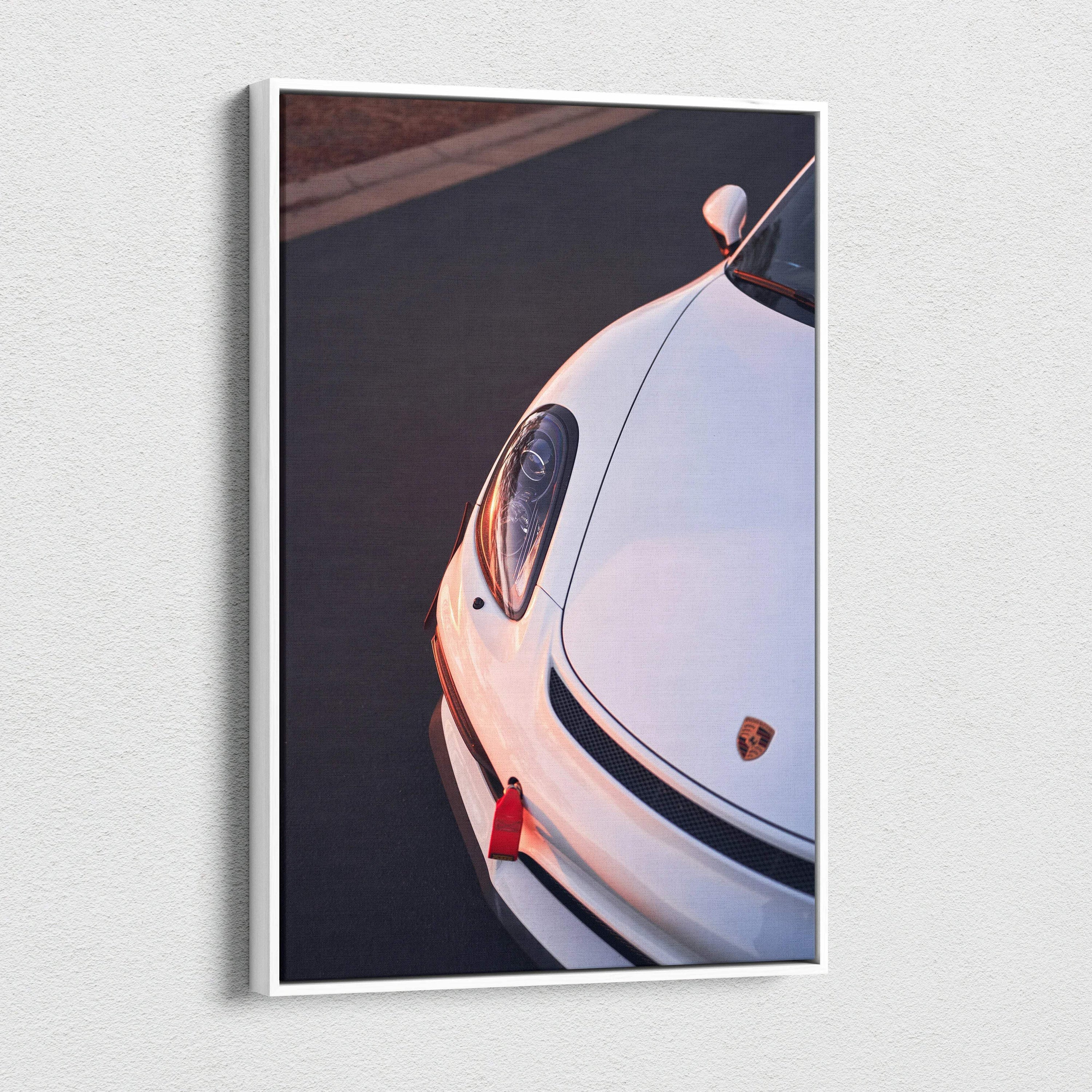 Vertical canvas wall art featuring a close-up of a white Porsche GT4 headlight and front bumper details.