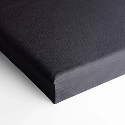 Close-up of black stretched canvas wall art corner with textured surface and neatly wrapped edges.
