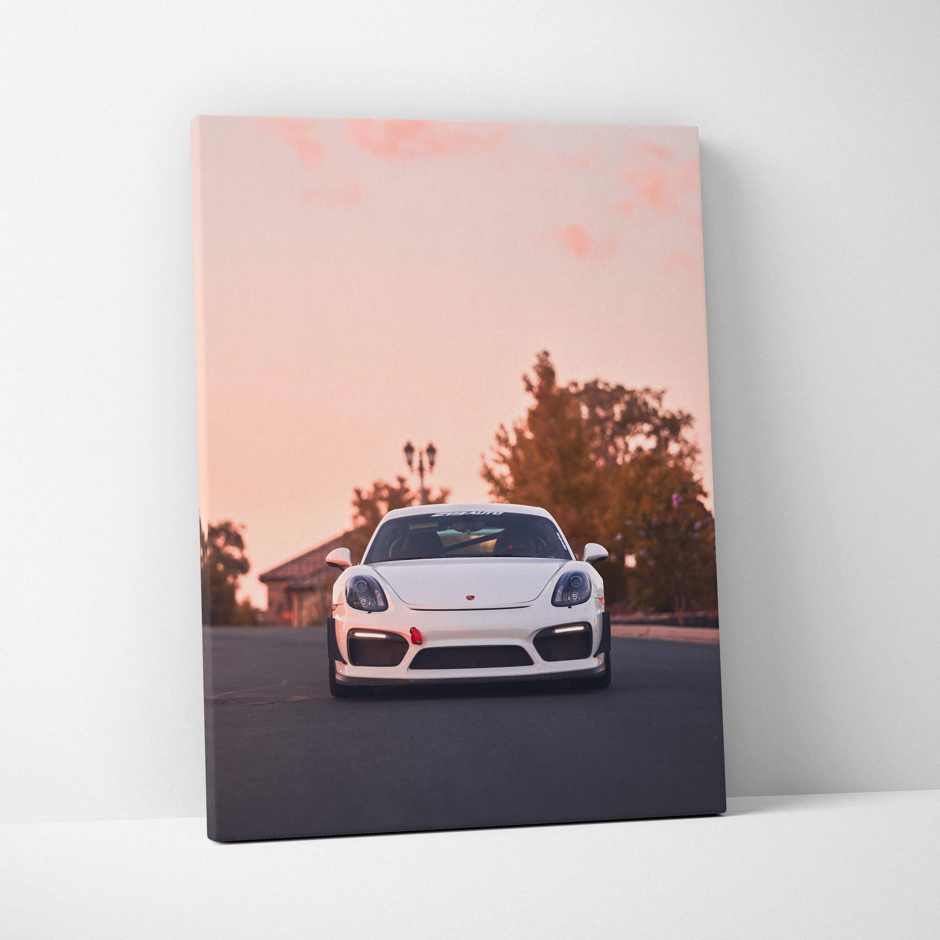 Porsche GT4 driving on road at sunset canvas wall art with warm orange sky.