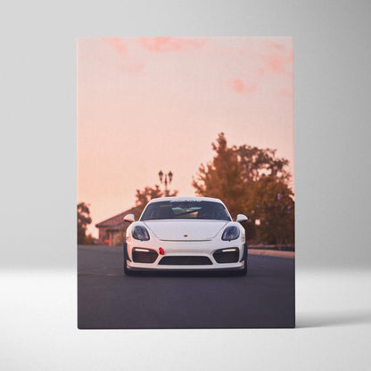 White Porsche GT4 sports car on road at sunset printed on vertical canvas wall art.