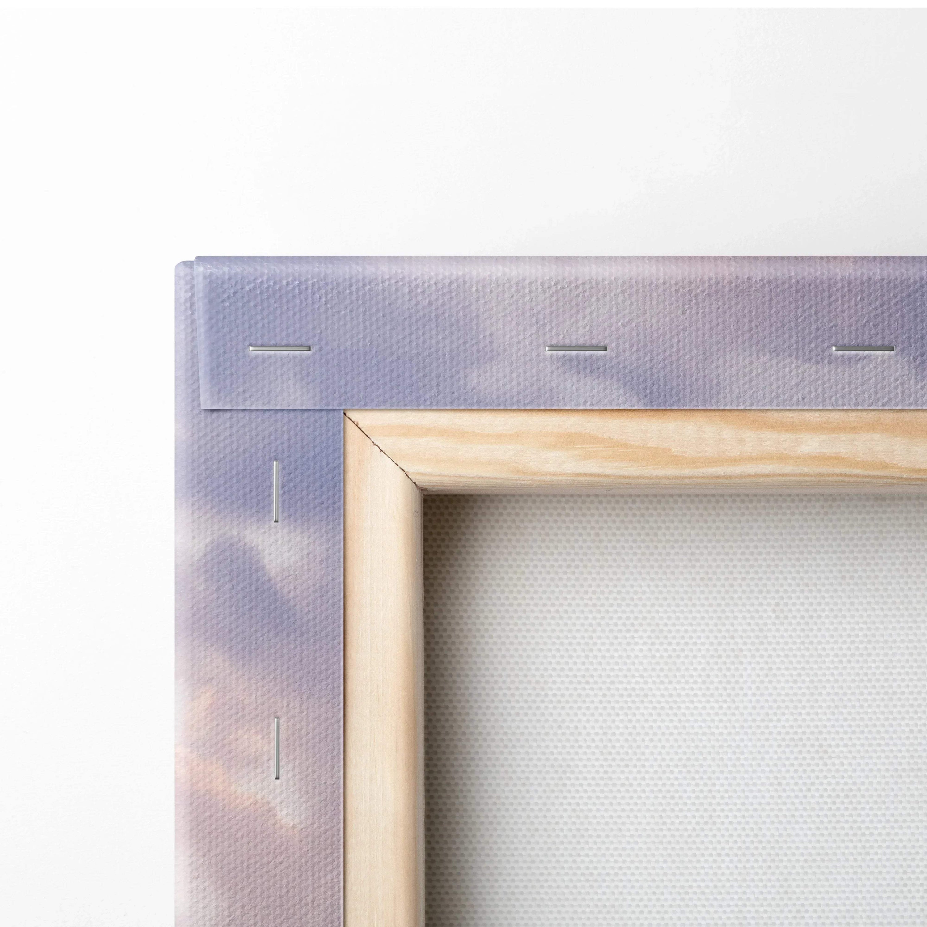 Close-up of stretched canvas wall art with wooden frame and stapled edges in vertical format.
