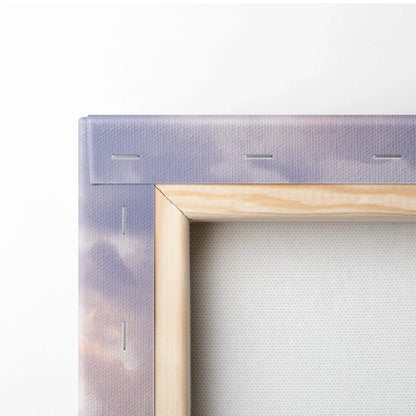 Close-up of stretched canvas wall art with wooden frame and stapled edges in vertical format.