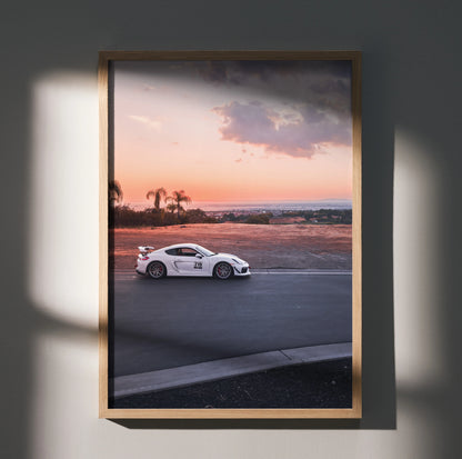Porsche GT4 racing car driving on track at sunset framed wall art poster.