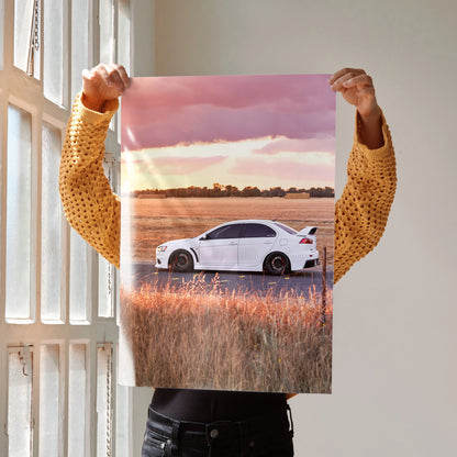 Mitsubishi Evo 10 poster wall art featuring white car parked in field at sunset with pink sky.