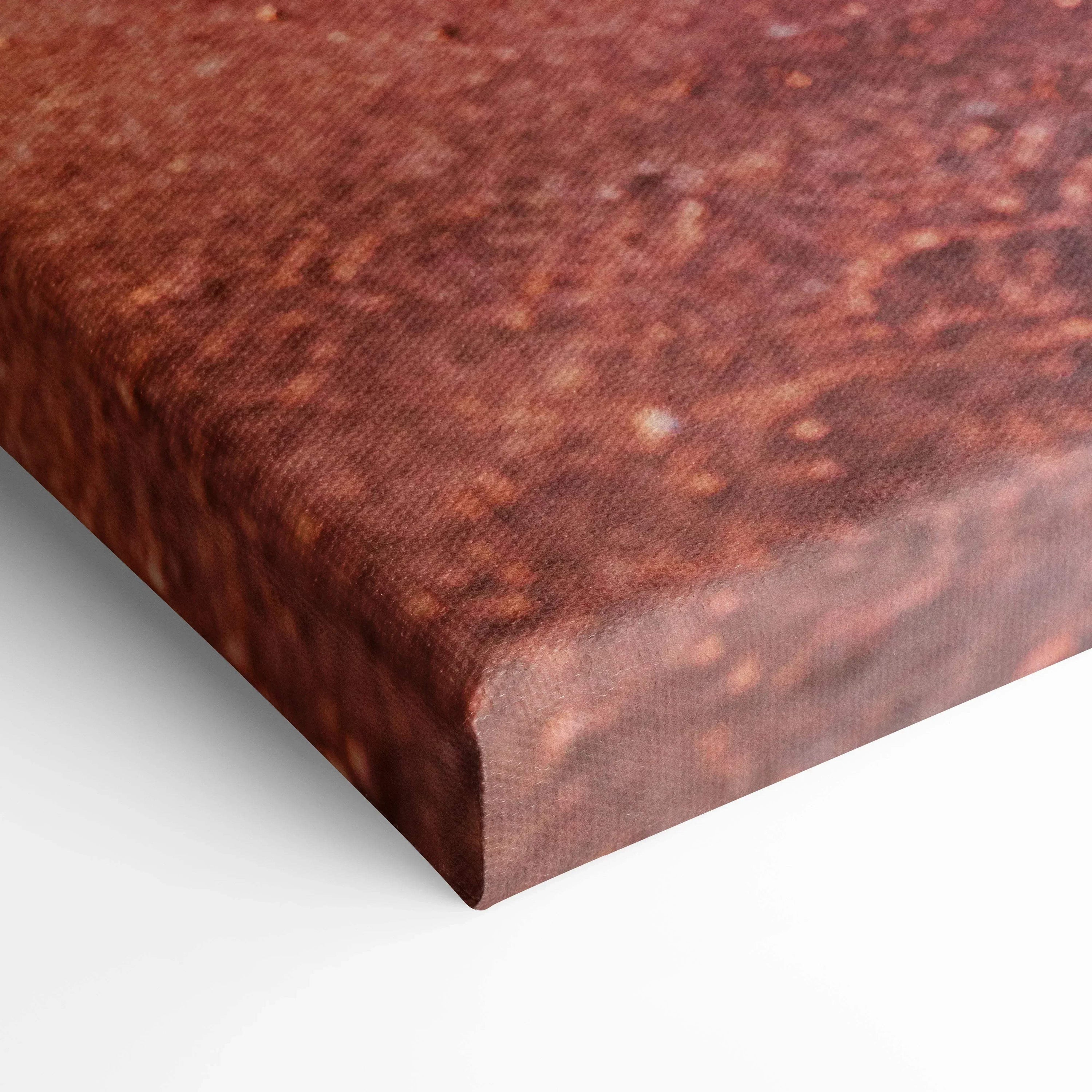 Close-up of textured canvas wall art with rich sunset hues and warm orange tones.