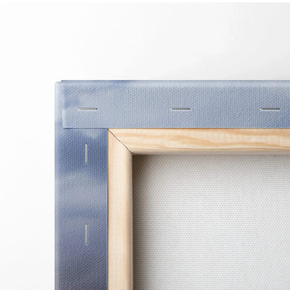 Close-up of natural wood frame and blue-stretched canvas corner for wall art print.