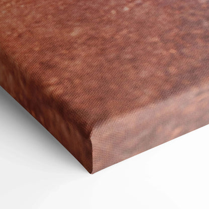 Close-up of textured brown canvas wall art with tight, woven fabric detail on wrapped edge.