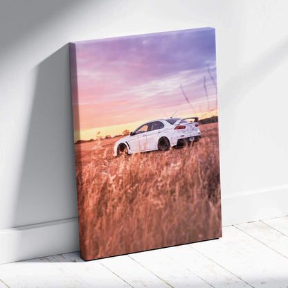 Mitsubishi Evo 10 parked in field at sunset on vertical canvas wall art with vivid colors.