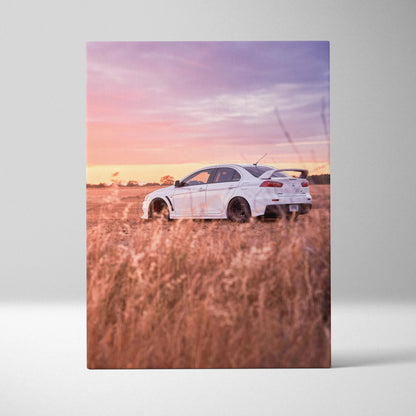 Mitsubishi Evo 10 in white parked in golden field under pink sunset sky canvas wall art.