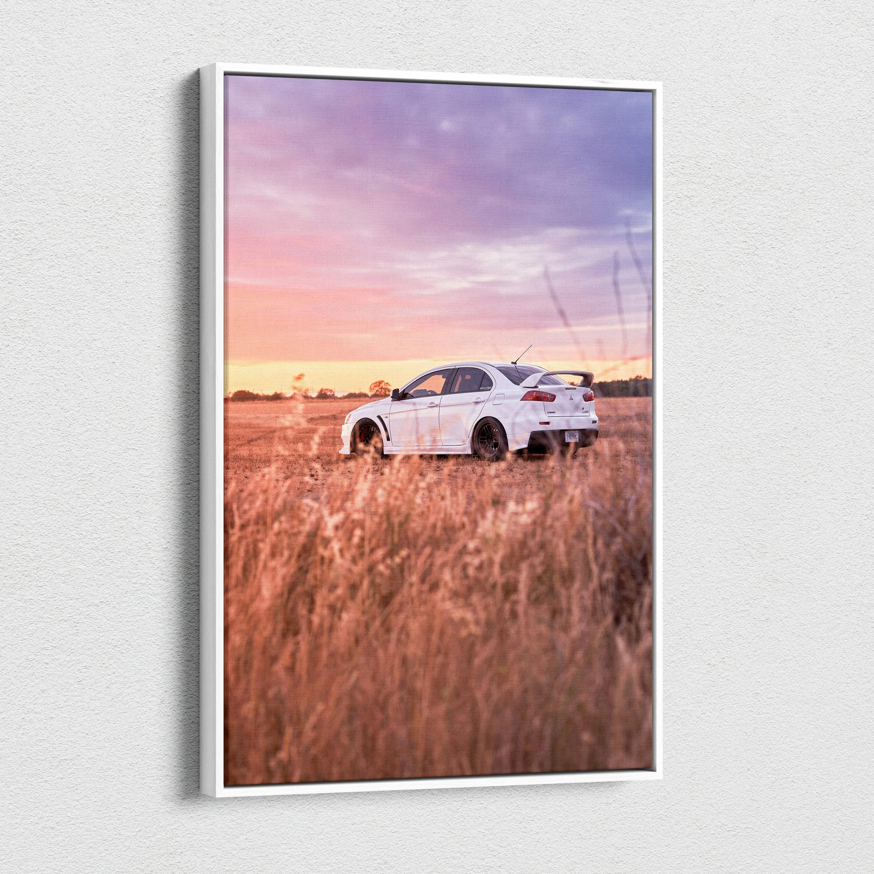 Vertical canvas wall art featuring a white Mitsubishi Evo 10 in a golden field under a pink and purple sunset sky.