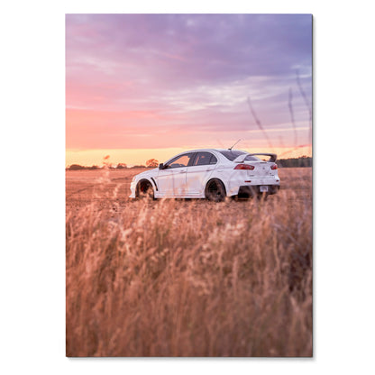 Mitsubishi Evo 10 parked in golden field at sunset with purple and orange sky poster wall art.