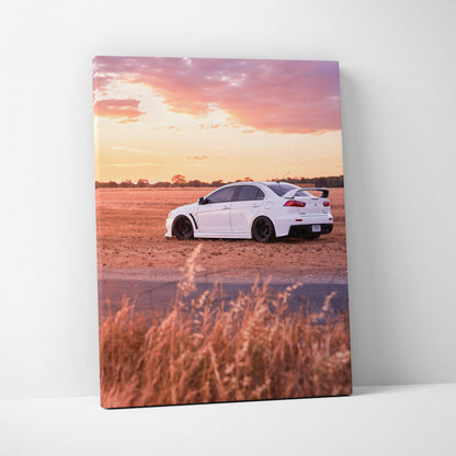 Mitsubishi Evo 10 parked on dirt road at sunset with purple and orange sky canvas wall art.