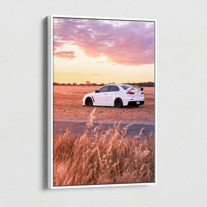 Vertical canvas wall art of a white Mitsubishi Evo 10 parked on rural road at sunset.