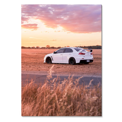 Mitsubishi Evo 10 parked on dusty road at sunset with vibrant sky poster wall art.