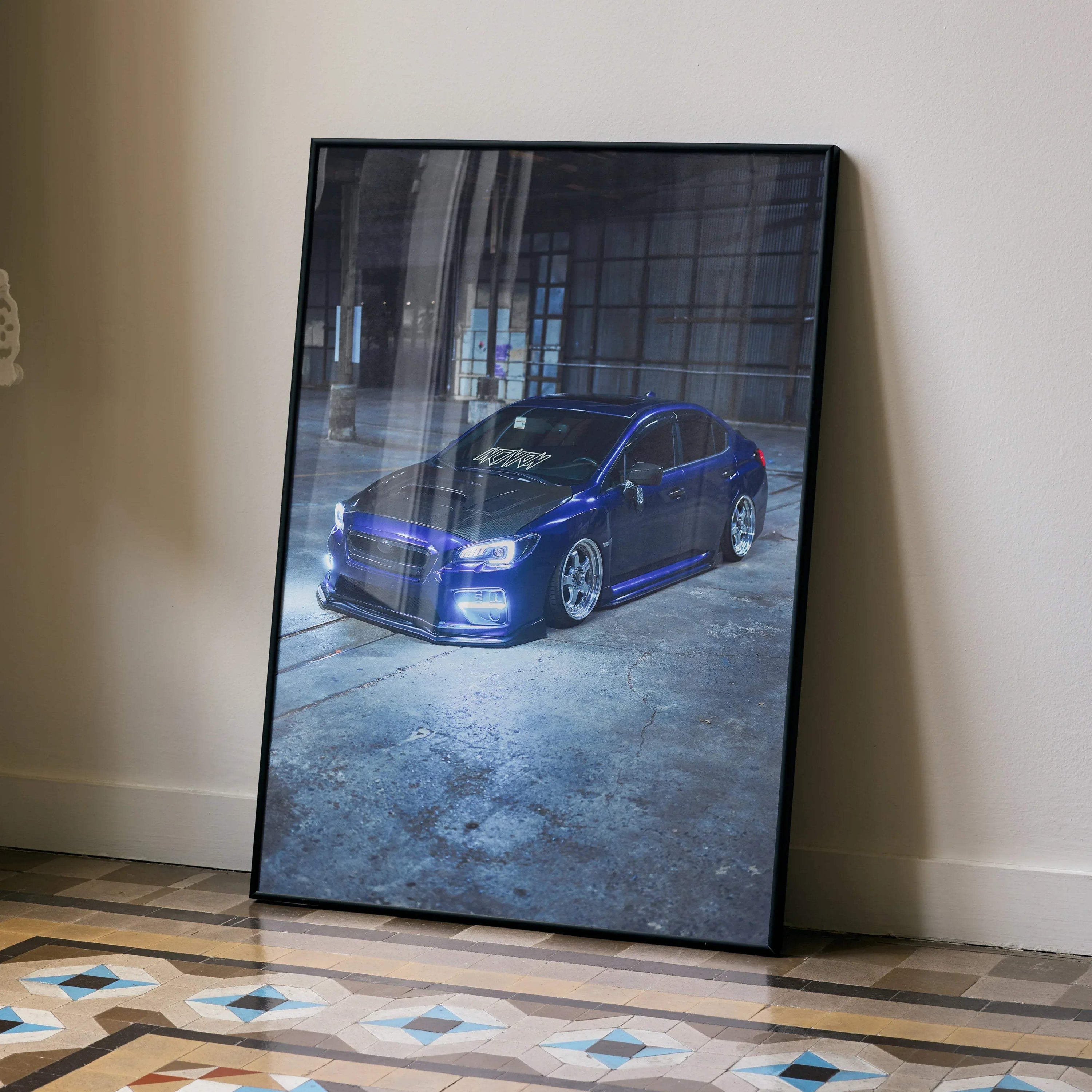 Subaru WRX blue sports car poster framed as wall art leaning on patterned floor against beige wall.