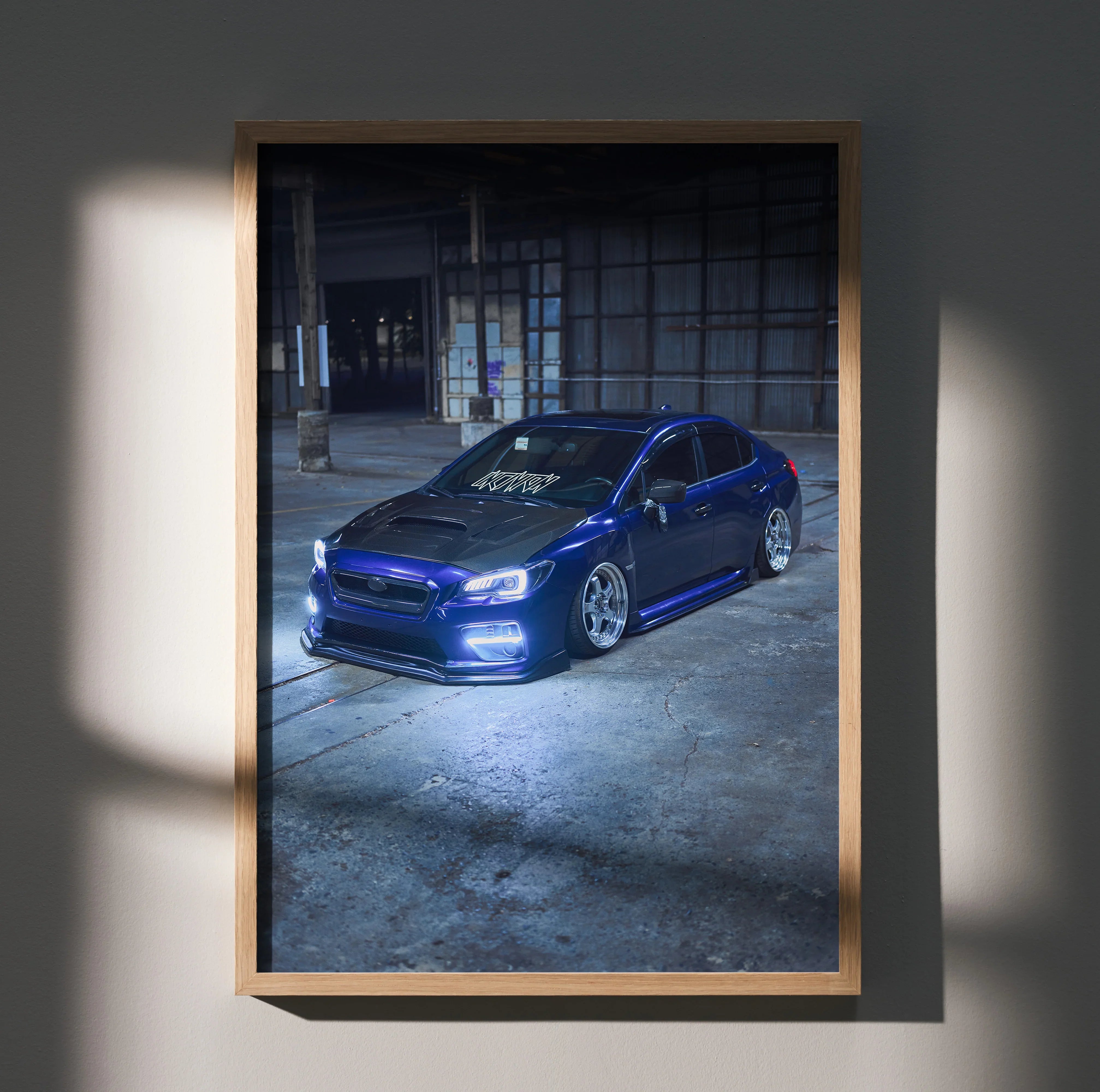 Subaru WRX blue car poster with sleek design displayed as wall art in wooden frame.