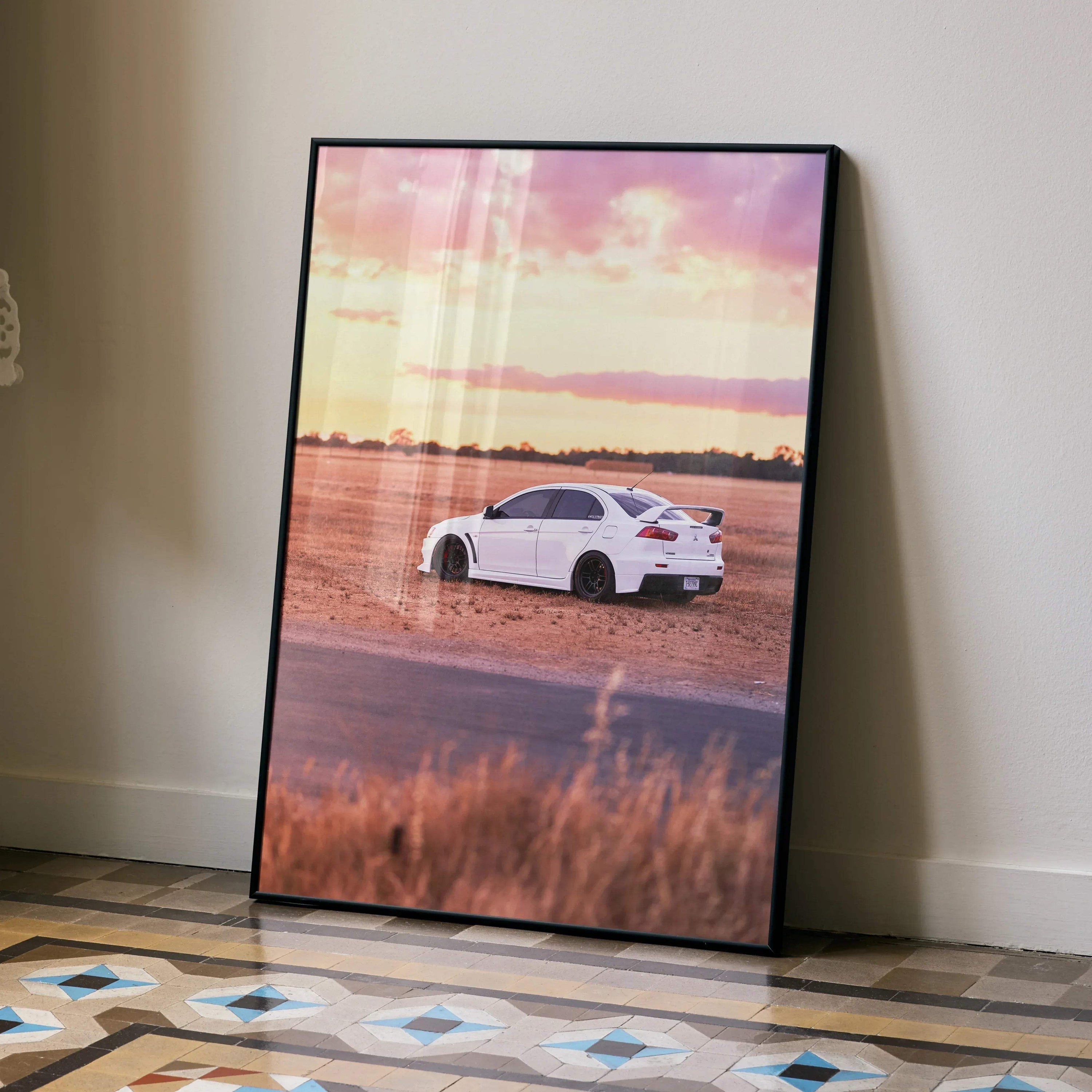 Mitsubishi Evo 10 poster featuring a white car on a dirt road at sunset, wall art with scenic background.