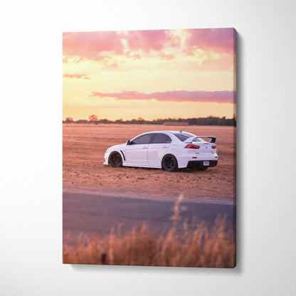 White Mitsubishi Evo 10 on dirt road at sunset vertical canvas wall art.