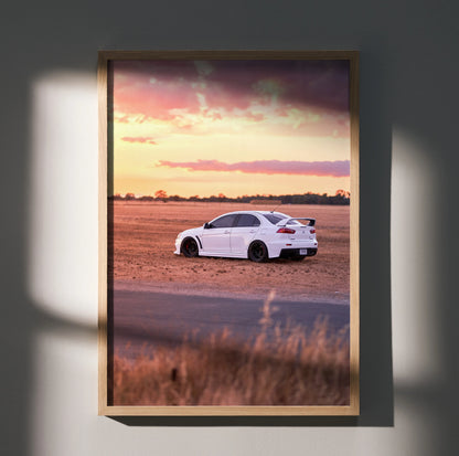 Mitsubishi Evo 10 on dirt road at sunset poster wall art in wooden frame.