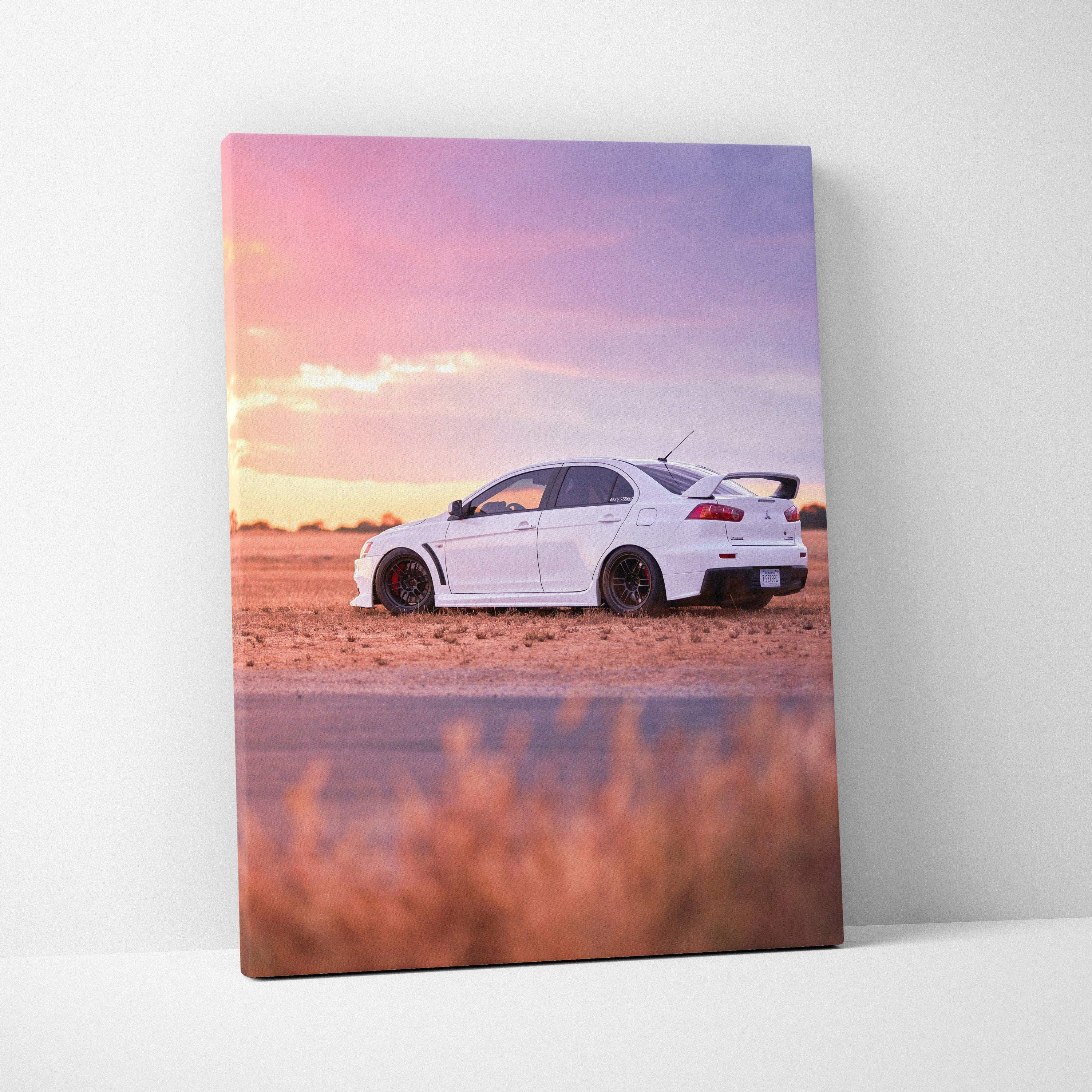 White Mitsubishi Evo 10 parked on dirt at sunset canvas wall art print vertical orientation.