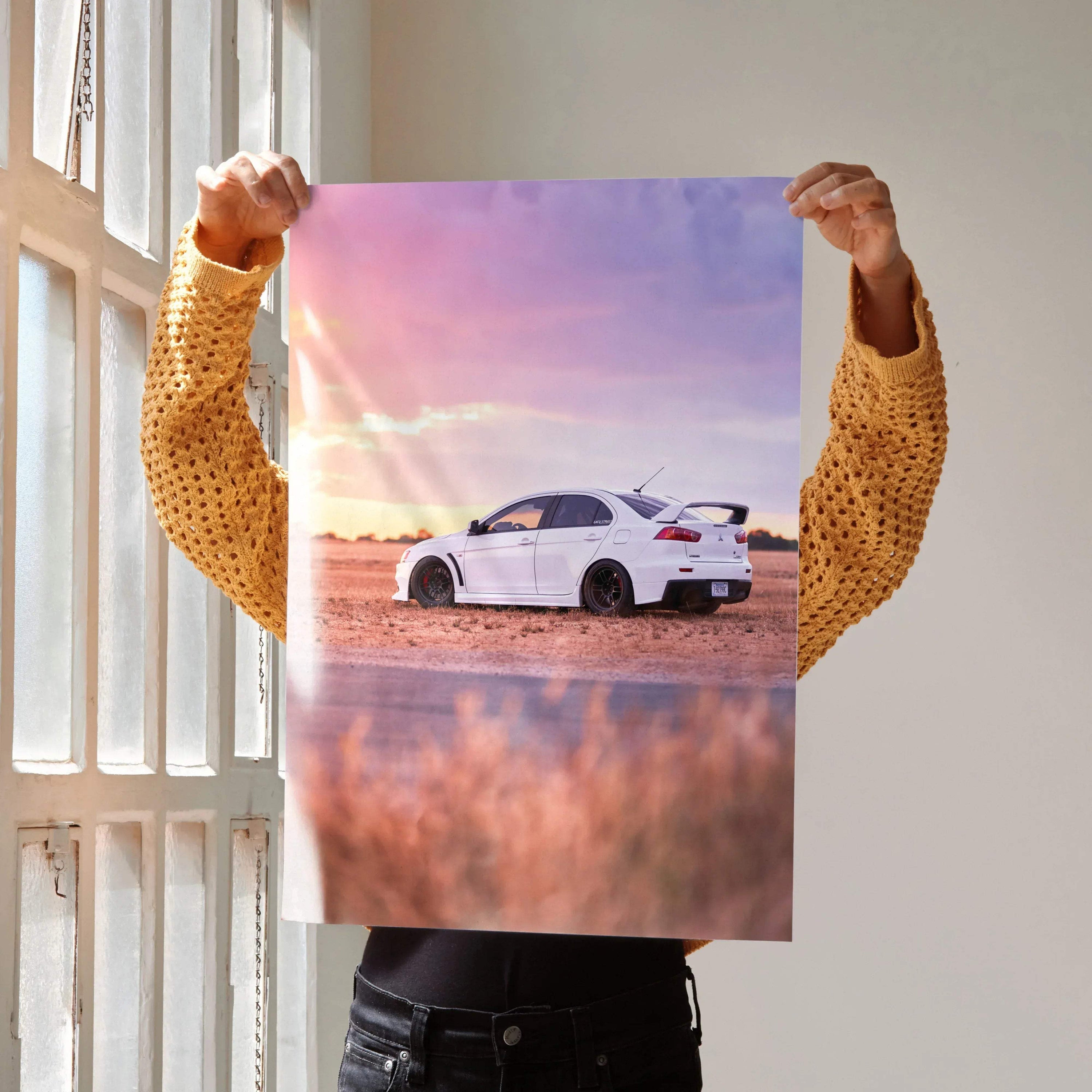 Mitsubishi Evo 10 white car poster at sunset with warm sky tones, wall art for automotive fans.