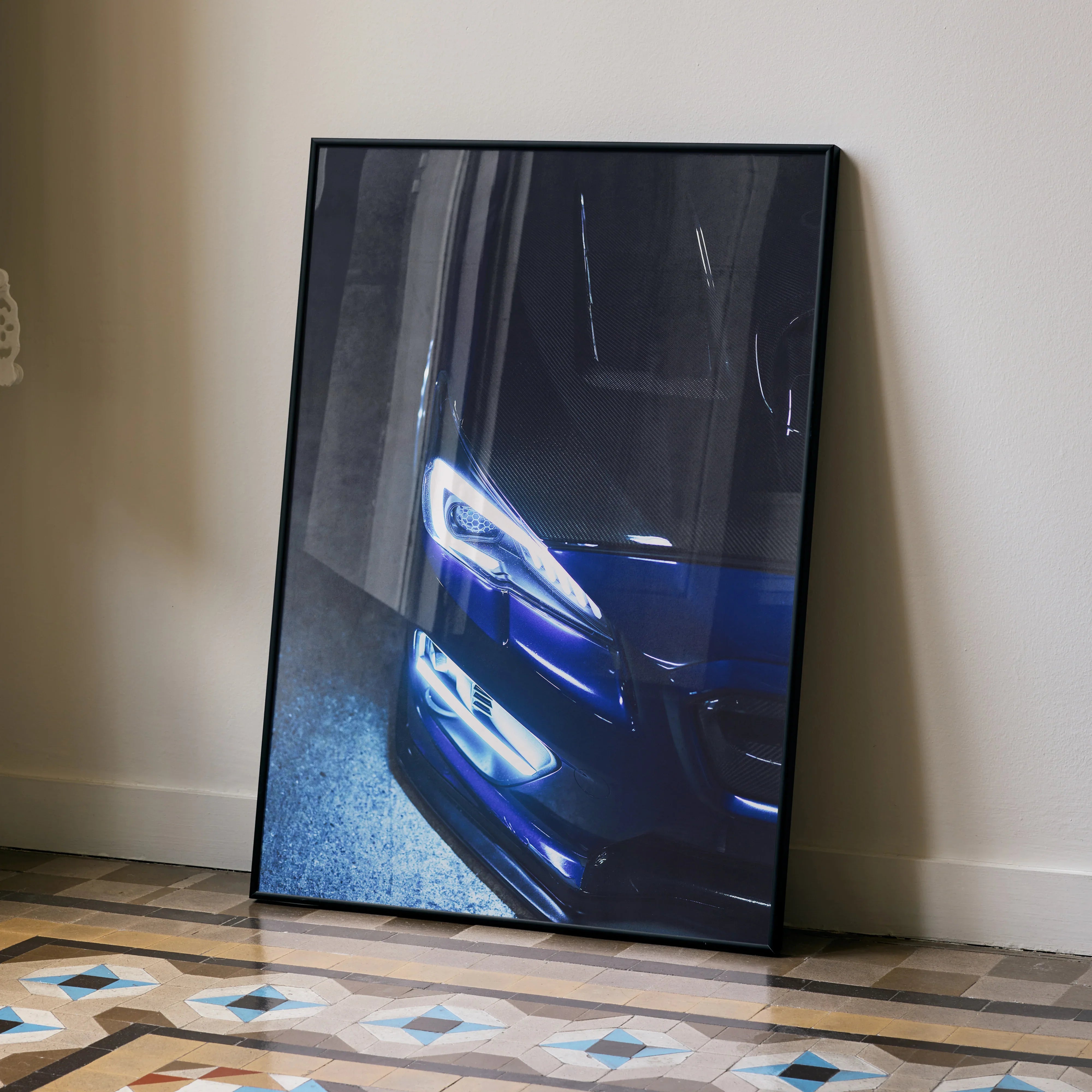 Subaru WRX front close-up in dark blue poster leaning against wall on patterned floor wall art.