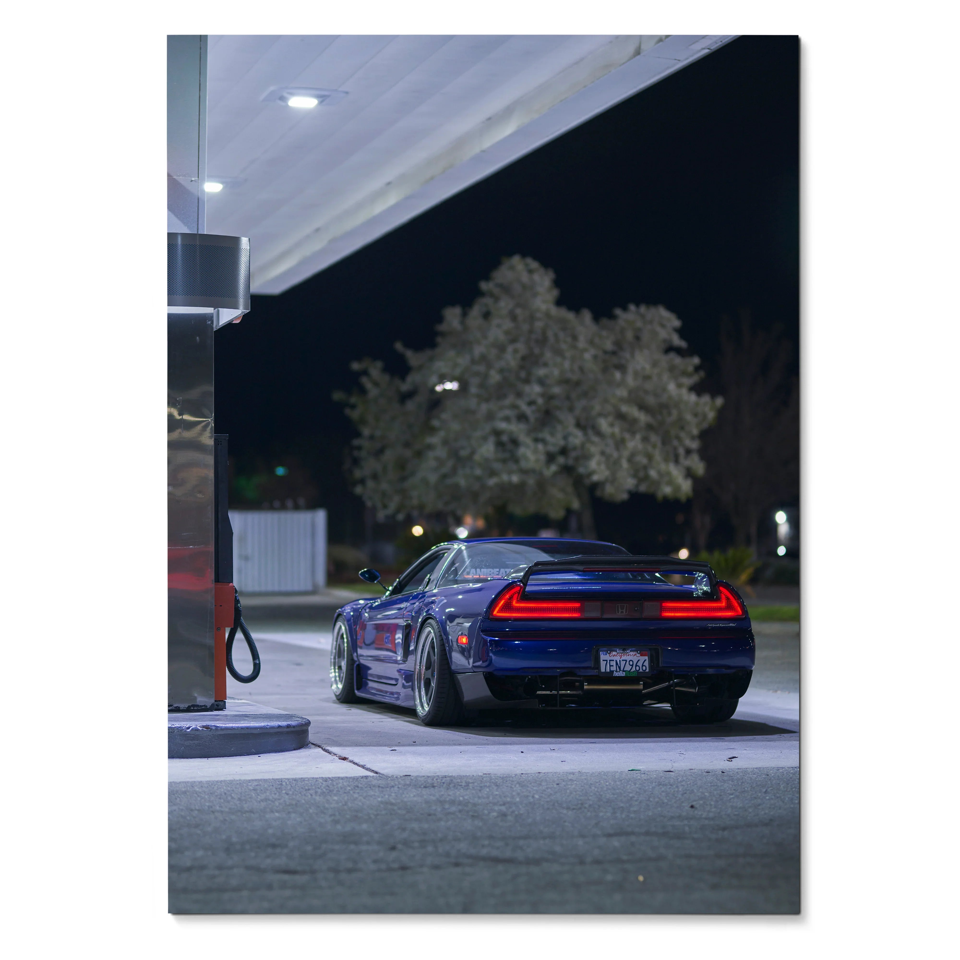Acura NSX poster featuring sleek black sports car rear at gas station under night sky wall art.