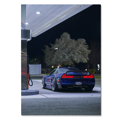 Acura NSX poster featuring sleek black sports car rear at gas station under night sky wall art.