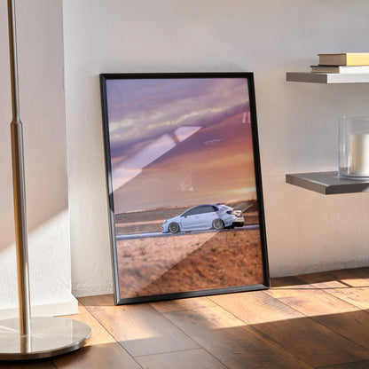 Subaru WRX poster wall art with white car on desert road under vibrant purple and orange sunset sky.
