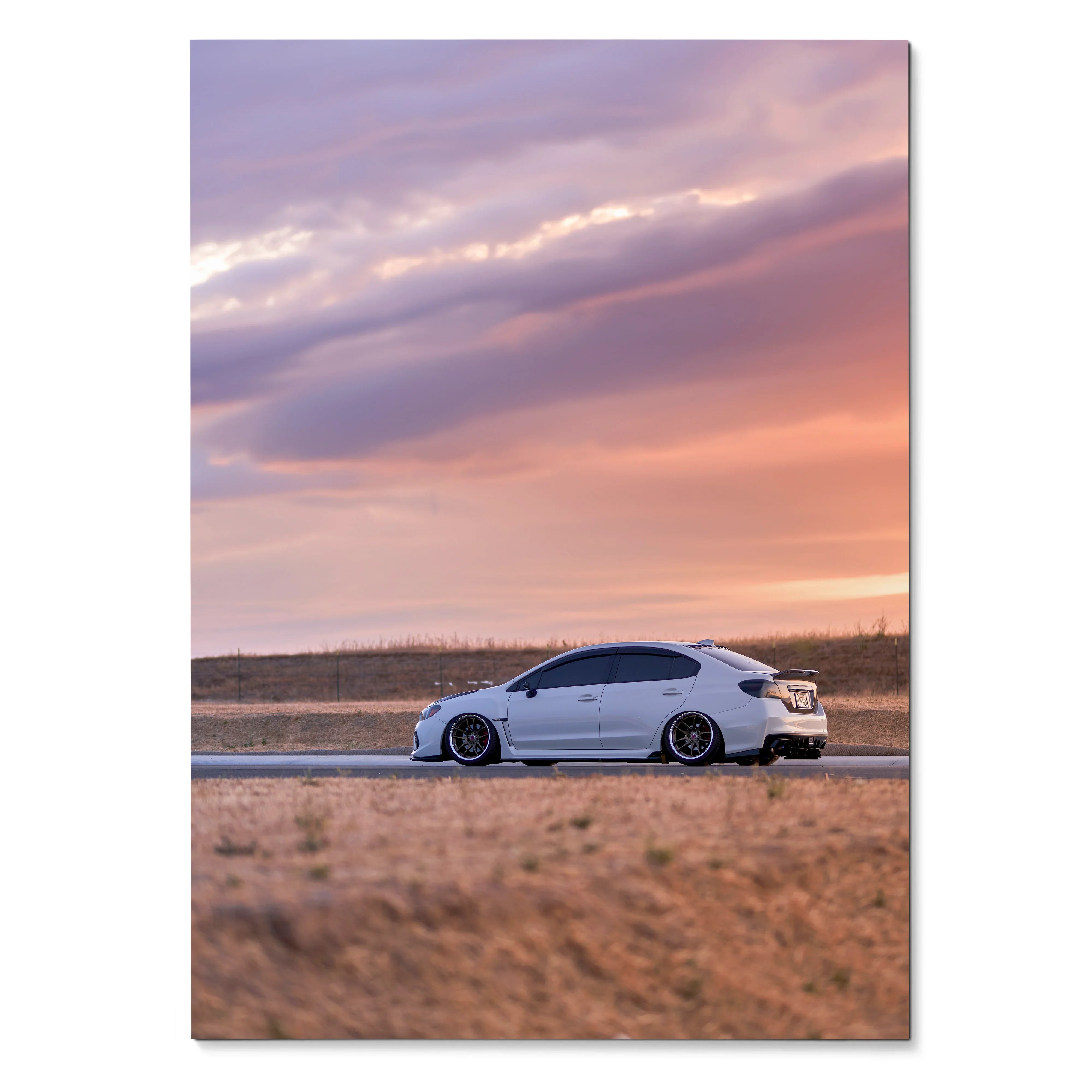 Subaru WRX white car on road at sunset with purple orange sky poster wall art.