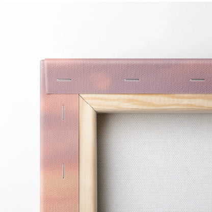 Close-up of wooden stretcher bars and stapled pink canvas corner for vertical wall art print.