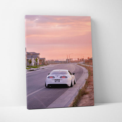 Toyota Supra MK4 on road at sunset vertical canvas wall art with soft pink sky.