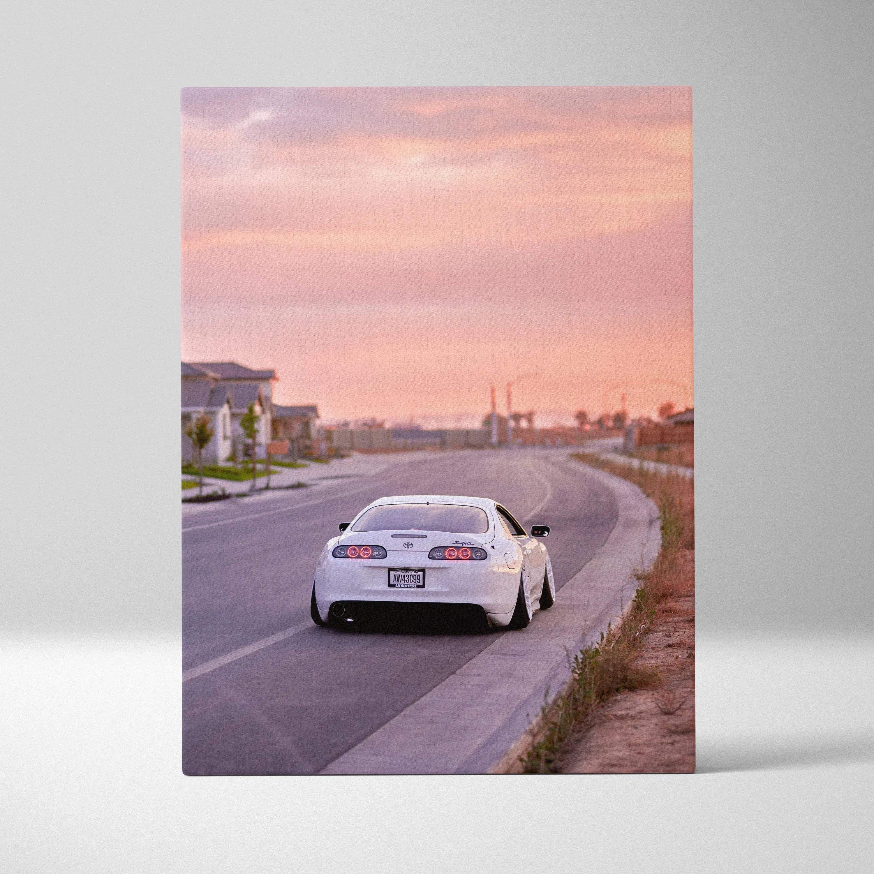 White Toyota Supra MK4 on urban road at sunset canvas wall art vertical print.