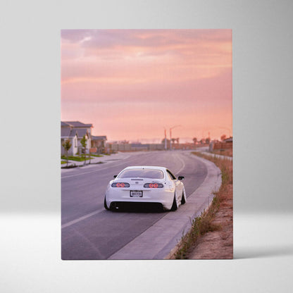 White Toyota Supra MK4 on urban road at sunset canvas wall art vertical print.