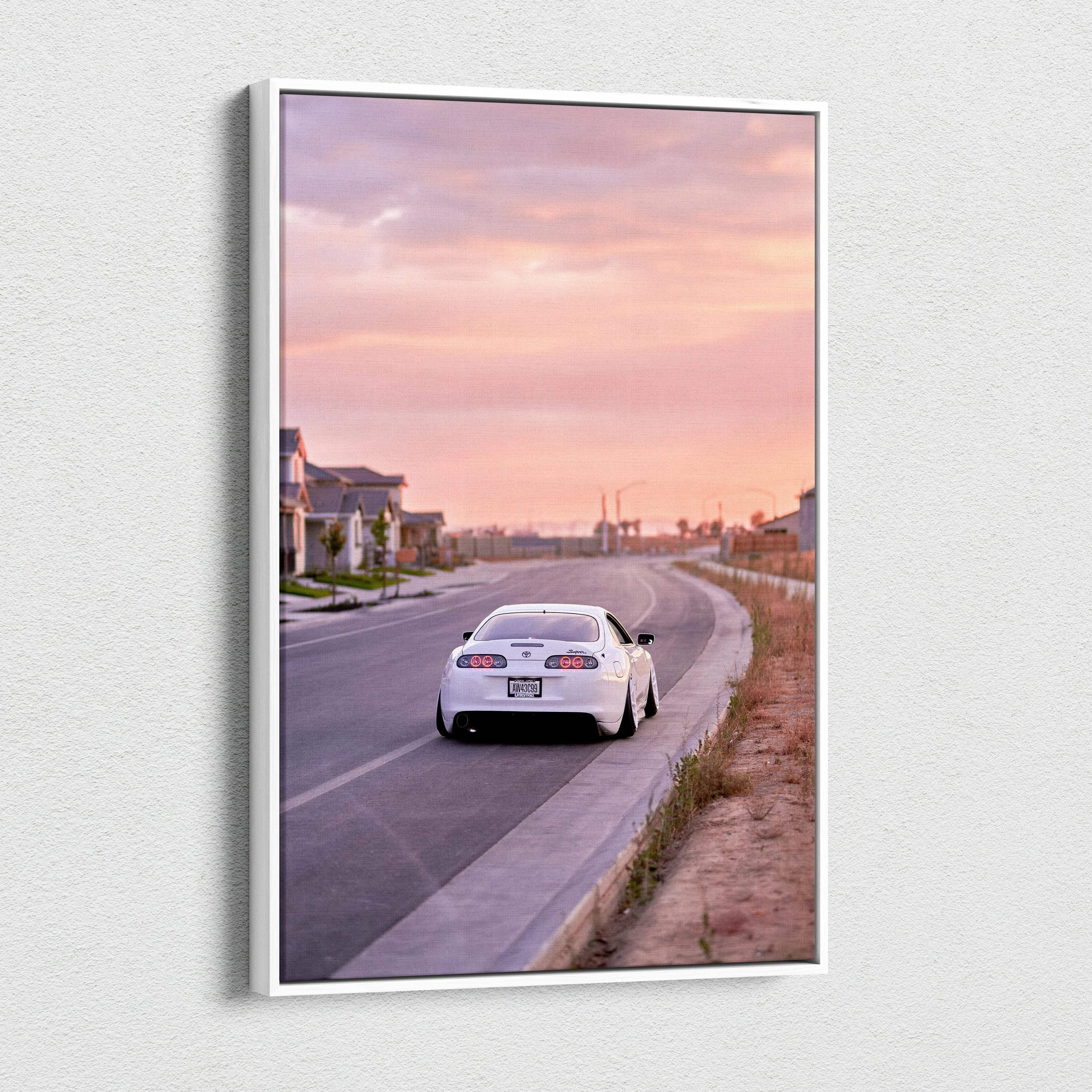 Toyota Supra MK4 on road at sunset vertical canvas wall art with pink sky.