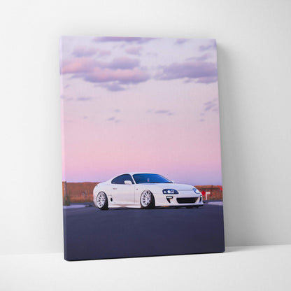 Toyota Supra MK4 white sports car against pastel sunset sky on vertical canvas wall art.