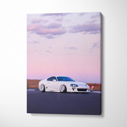 White Toyota Supra MK4 on road at sunset with pink sky, vertical canvas wall art.